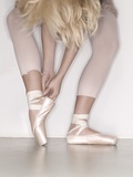 Ballerina adjusting toe shoe Photographic Print by November 