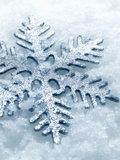 Snowflake Shaped Christmas Ornament Lying in the Snow Photographic Print