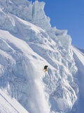 Skier going over edge of cliff Photographic Print by John Norris