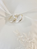 Close up of wedding rings on pillow Photographic Print by Jamie Grill