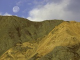 Full moon setting over mountain in Kluane National Park Photographic Print by John Eastcott & Yva Momatiuk
