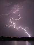 Lightning Striking Ground Near Residential Lake Fotografie-Druck von Jim Reed