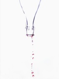 Liquid pouring out of empty bottle Photographic Print by Dermot Conlan