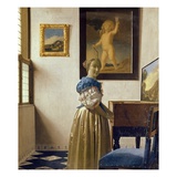 A Young Woman Standing at a Virginal Photographie par Jan Vermeer
