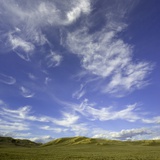 Lofty cumulus and cirrus clouds over sagebrush prairie Photographic Print by John and Yva Eastcott And Momatiuk