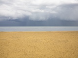 Beach with brooding sky Photographic Print by Ashley Jouhar