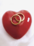 Wedding rings on heart Photographic Print