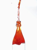 Liquid pouring out of water bottle Photographic Print by Dermot Conlan