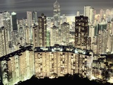 Hong Kong skyscrapers and apartment blocks at night Photographic Print by Martin Puddy
