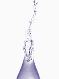 Liquid pouring out of water bottle Photographic Print by Dermot Conlan