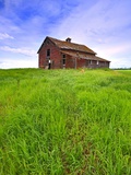 Abandoned red barn sitting on the top of a hill on a pioneer homestead in rural Alberta Canada Photographic Print by Robert McGouey