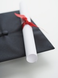 Close up of diploma and graduation cap Photographic Print