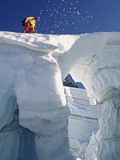 Climber crossing snow bridge on coleman glacier Photographic Print