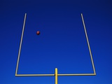 Football Flying Through Goalpost Photographic Print by Mark Karrass