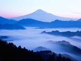 Distant view of Mount Fuji silhouetted against blue sky Photographic Print