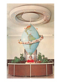 Receptionist in Front of Elongated Globe Posters