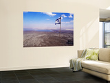 The Blue and White Flag of Israel, the Star of David Flies over the Deserts of Masad Print by Russell Mountford