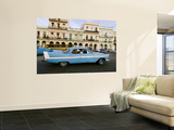 Classic 1950's Car Driving Through Downtown Posters by Christian Aslund