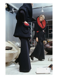 Vogue - September 1972 - Woman Tries on a Pierre Cardin Fur Coat Photographic Print by Kourken Pakchanian
