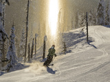 Skiing Through a Sundog on Corduroy Groomed Runs at Whitefish Mountain Resort, Montana, Usa Photographic Print by Chuck Haney