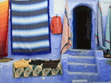 Blue Doorway and Traditional Moroccan Fabrics, Chefchaouen, Morocco, North Africa, Africa Photographic Print by Guy Edwardes