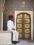 Palace Guard Sitting at Rose Gate in Pitam Niwas Chowk, City Palace, Jaipur, Rajasthan, India, Asia Photographic Print by Ian Trower