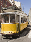 A Number 28 Tram Runs Along the Scenic Route Popular With Tourists in the Alfama District of Lisbon Photographic Print by Stuart Forster