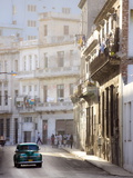 Old American Car Driving Along Quiet Street in Havana Centro, Havana, Cuba Photographic Print