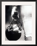 Low Angle View of an American Football Player Holding a Helmet Impressão fotográfica emoldurada