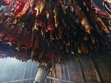 A Fisherman Checks the Salmon in His Smokehouse for Dryness Photographic Print by Michael Melford
