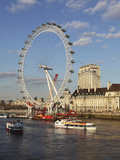 Cruise Boats Sail Past County Hall and the London Eye on the South Bank of the River Thames, London Photographic Print by Stuart Forster