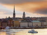 Sweden, Stockholm, Riddarfjarden, Gamla Stan, Passenger Ferries in Bay at Dusk Photographic Print by Shaun Egan