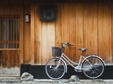 Japan, Chubu Region, Kyoto, Gion, a Bicycle Rests Against the Wall of a Traditional Building Photographic Print by Nick Ledger
