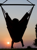 Malawi, Lake Malawi National Park, Young Guest Relaxes in a Hammock at Pumulani Lodge, (MR) Photographic Print by John Warburton-lee