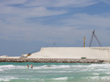 Tourists in the Surf Near a Project to Create New Land Photographic Print by Ashley Cooper
