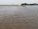Agricultural Flooding from a Thunderstorm Covers a Rural Road in Western Nebraska Photographic Print by Jon Van de Grift