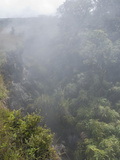 Volcanic Fog (Or "Vog") Reduces Visibility and Partially Obscures a Ravine in Hawaii, USA Photographic Print by Jon Van de Grift