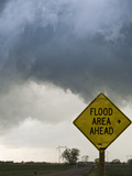 A Road Sign Warns of Flooding on a Rural Road in Kansas as a Tornadic Thunderstorm Spins Above Fotografie-Druck von Jon Van de Grift