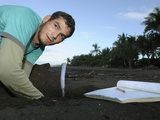 A Costa Rican Researcher Monitoring the Temperature in the Developing Olive Ridley Sea Turtle Nest Photographic Print by Solvin Zankl