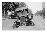 Automobile's Front Axel Breaks Splaying Tires Outward Causing Vehicle to Rest on its Front Bumper. Poster