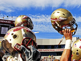 Florida State University - Football Helmets Held High Photographic Print by Mike Olivella