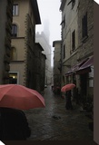 Volterra, Red Umbrellas Stretched Canvas Print by Richard Desmarais