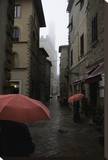Volterra, Red Umbrellas Stretched Canvas Print by Richard Desmarais