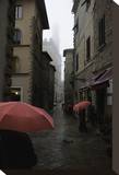 Volterra, Red Umbrellas Stretched Canvas Print by Richard Desmarais