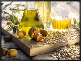 Various Oils in Carafes, Olives, Sunflower Seeds Framed Canvas Print by Peter Rees