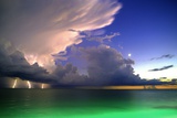 Lighting striking over green and blue water Prints by Richard Broadwell