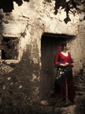 A Young Spanish Woman Wearing Traditional Flamenco Dress Standing in a Doorway to an Old Building Photographic Print by Steven Boone
