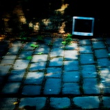 An Old Computer Monitor on Cobbles Photographic Print by Mark James Gaylard