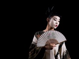 A Young Japanese Woman Wearing a Kimono and Holding a Fan Photographic Print by Leonora Saunders