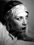 The Face of a Young Woman Wearing a Headband and Long Earings Photographic Print by Leonora Saunders